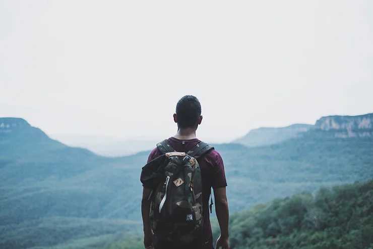 An image of a backpacker heading towards the horizon