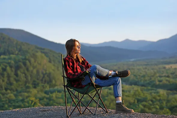 a woman sitting on a camping chair